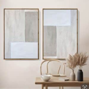Neutral framed abstract wall art pair above wooden table with pampas grass and ceramics, minimalist Scandinavian decor.