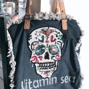 Fringed denim tote with sequin sugar skull and 'Vitamin Sea' text, tan leather straps—boho beach bag.